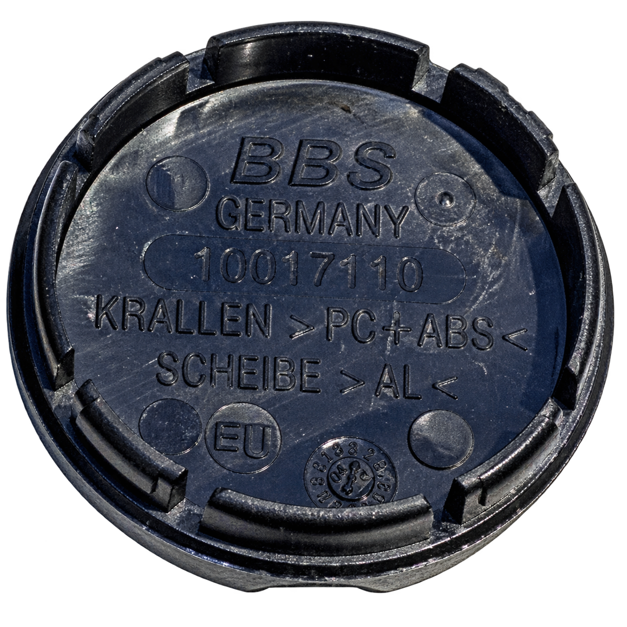 Backside of a BBS Type A center cap showing four retention tabs