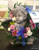Seated cherub with floral garland