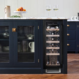 Black glass Caple WI3126BG Sense Wine Cooler seamlessly fitted into a dark blue kitchen island with 