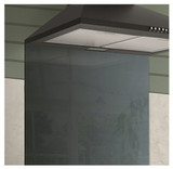 Caple TSB600 Splashback installed below black cooker hood in a kitchen with green walls.