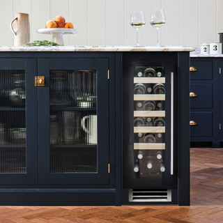 Caple WI3155 Wine Cooler in black glass seamlessly integrated into a sleek, dark blue kitchen island