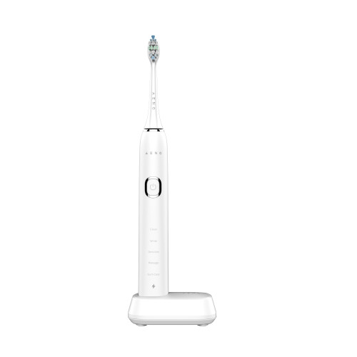 Aeno DB5 electric toothbrush with wireless charging base in use.