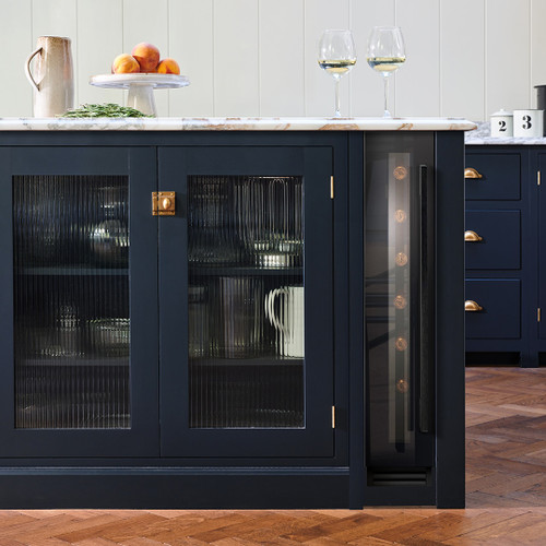 Black Glass Caple WI158BG Sense Wine Cooler installed in navy blue kitchen cabinetry with marble wor