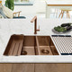Modern kitchen showcasing Caple's MODE3415 1.5 bowl kitchen sink in copper with matching tap on a ma