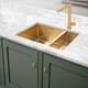 Modern Caple MODE3415 1.5 Bowl kitchen sink with gold tap in marble countertop over green cabinets