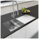 Caple Novato Pull Out Spray Kitchen Tap in use in a modern kitchen with vegetables on countertop