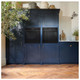 Caple WD140 Warming Drawer below compact microwave oven built into blue kitchen cabinetry in kitchen