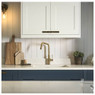 Abode Hex Single Lever Kitchen Tap in use on a modern blue kitchen sink area with white countertops