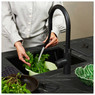 Quooker Flex boiling water tap in black, showcased against in a modern grey and black kitchen