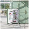 Caple RIL125 larder fridge showcasing its spacious interior filled with food in a bright sunlit gree