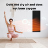 Woman using Aeno Premium 700W Smart Infrared Heating Panel during yoga session.