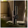 Abode Globe Single Lever Kitchen Tap in black with minimalist design on display in a dark kitchen