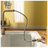 Abode fraction pull out kitchen tap with spray head in use over a kitchen sink