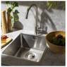 Abode Sway Single Lever Kitchen Tap in use over stainless steel sink with a wooden cutting board