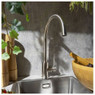 Abode Sway Single Lever Kitchen Tap in use on a stainless steel sink surrounded by wooden utensils