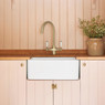 Caple Shaftsbury Kitchen Tap installed above a Belfast sink against a pink wooden backdrop.