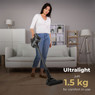 Woman effortlessly cleaning a modern living room using Aeno SC1 lightweight cordless vacuum which we