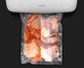 Raw chicken with sauce being sealed with the Aeno VS2 vacuum sealer.