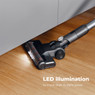 Aeno SC3 cordless vacuum with LED lights effortlessly cleaning under a cabinet.