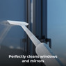 Aeno SM2 steam mop squeegee achieving streak-free results on windows and mirrors.
