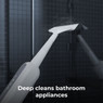 Aeno SM2 steam mop nozzle deep cleaning bathroom tiles with directed steam.