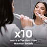 Woman uses Aeno DB5 electric toothbrush, demonstrating its 10x effectiveness over manual brushes.