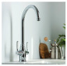 Abode Pronteau ProTrad 3 in 1 Monobloc Kitchen Tap installed on a sink, with kitchenware