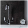 Abode Pronteau ProTrad 3 in 1 Monobloc Kitchen tap with white handles, next to a clock on dark wall