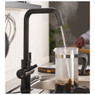 Pronteau Propure 4 in 1 Monobloc Quad Kitchen Tap in black, dispensing steaming hot water