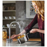 Woman filling pan using Abode's Pronteau Profile 4 in 1 3-Part Kitchen Tap for boiling water