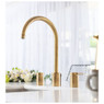 Pronteau Profile 4 in 1 3-Part Kitchen Tap in Antique Brass over a white sink in a bright kitchen