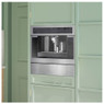 Caple CM465 Stainless Steel Coffee Machine seamlessly integrated into a green kitchen cabinets