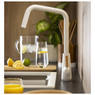 Pronteau by Abode PT1300 kitchen tap pouring water into glass, with pitcher and lemons nearby