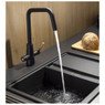 Pronteau by Abode PT1044 Scandi-E kitchen tap in black, next to a loaf of bread on a wooden chopping board