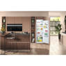 Hotpoint HS18012UK Tall Fridge stocked with fruit and veg in a modern pink kitchen with wooden islan