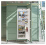 Caple RIL1796 larder fridge installed in green cabinets filled with fresh food demonstrating its spa