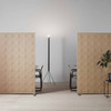 The Alumi acoustic screen adds a playful touch to space partitioning - circle pattern light brown panels - front view - in office.