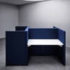 The Hive workstation has been designed to make the most of challenging layouts - dark blue and white tabletop - side and front view - in room.
