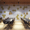 The Abstracta Airflake acoustic screen introduces functionality in style - white and yellow open blade panels - front view - in office.