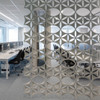 The Abstracta Airflake acoustic screen introduces functionality in style - white open blade panels - front view - in office.