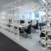 The Abstracta Airflake acoustic screen introduces functionality in style - white open blade panels - door pattern - front view - in office.