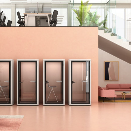 The built-it PoppinPod Om Stand represents a sustainable and energy efficient solution for office privacy - white - in office - 4 booths - with and without chairs - doors closed - front view.