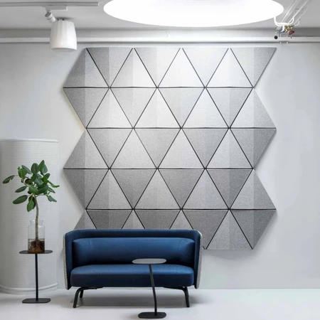 The Bits Wall by Abstracta transforma style into an acoustic formula for noise absorption and echo prevention  -  light and dark grey panels - white background logo