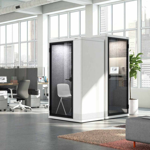 The built-it PoppinPod Om Stand represents a sustainable and energy efficient solution for office privacy - white - in office - 2 booths one with a chair inside and with right side view and the second one is seen from the left side.