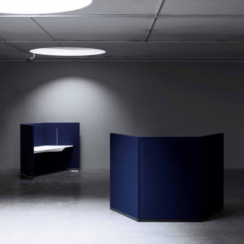 The Hive workstation has been designed to make the most of challenging layouts - dark blue and white tabletop - side and back view - in room.