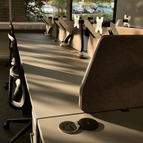 Delta 38 angled acoustic desk screens on bench desks in a modern office