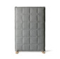 A soft and cosy-looking, sound-absorbent screen upholstered in thick, padded fabric with grid-patterned stitching