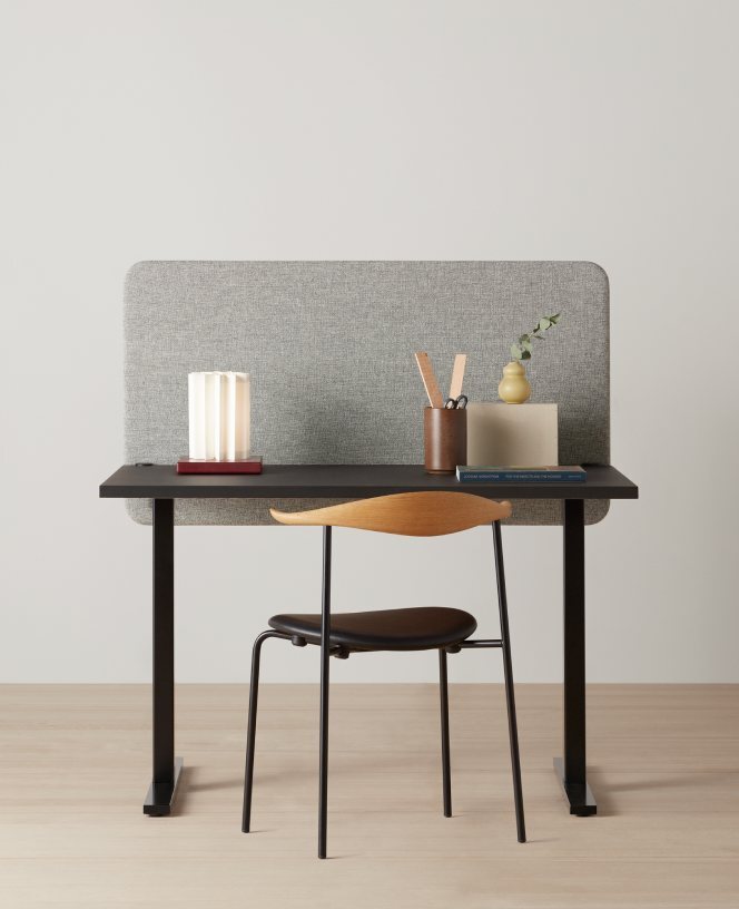 Grey fabric acoustic screen on a desk