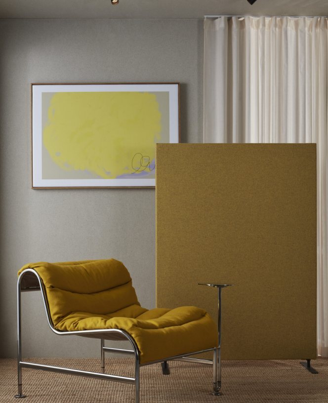 Mustard acoustic screen beside a lounge chair