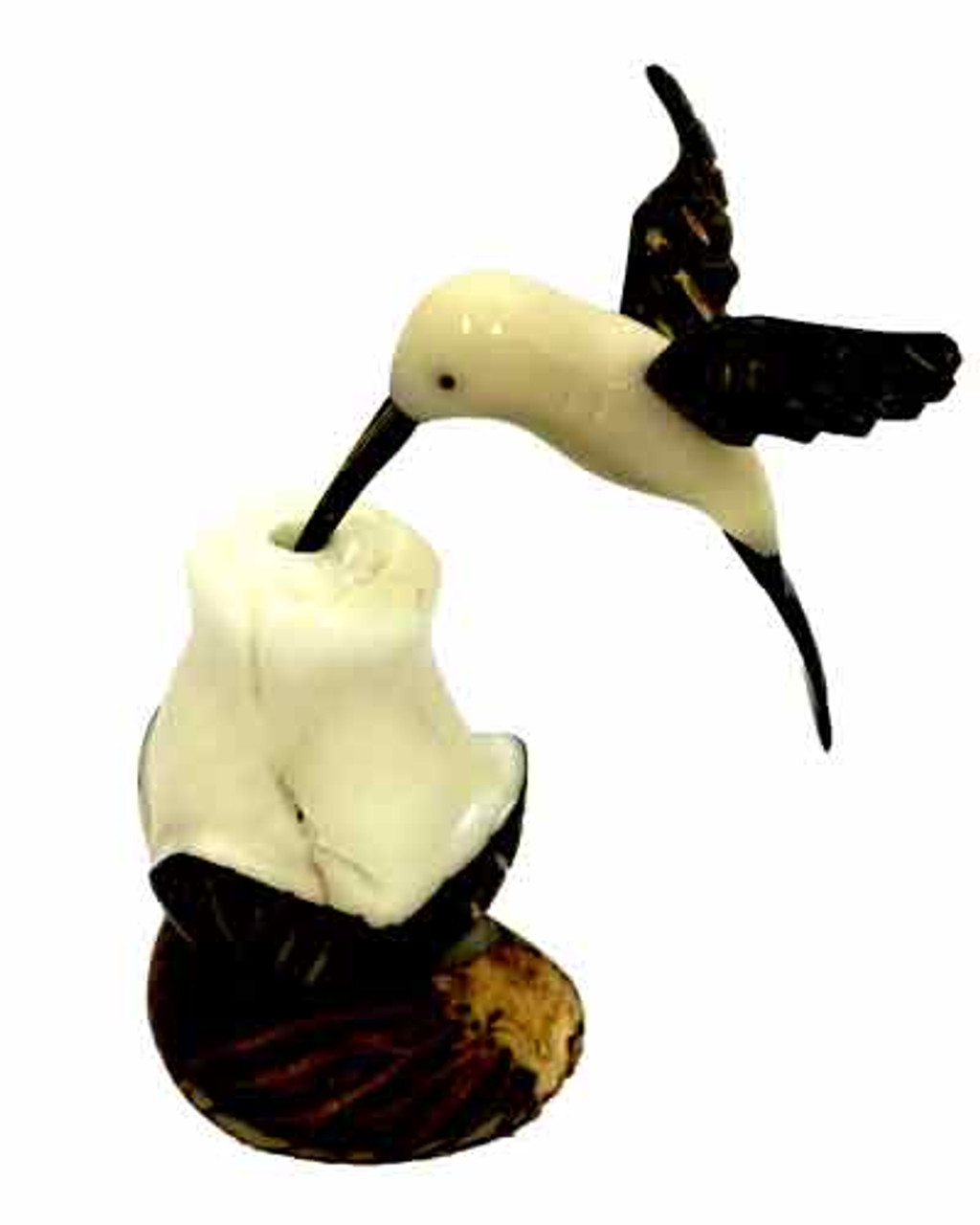 A hummingbird feeding on a rose made from Tagua nuts.  The outside of the tagua nut is brown with the inside being an ivory white.